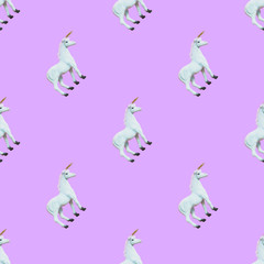 Wall Mural - seamless pattern of white unicorns on purple background