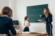 © undrey - School lesson Teacher and pupil write on a blackboard