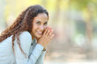 © Antonioguillem - Happy mixed race woman posing looking at camera in a park
