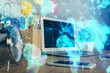 © peshkova - Double exposure of business theme icons and work space with computer background. Concept of success.