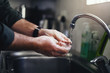 © StratfordProductions - Man washing hand with kitchen sink faucet