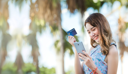 Wall Mural - Young asian woman shopping online with smartphone