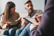 © Drobot Dean - Photo of puzzled irritated couple having conversation with psychologist on therapy session in room