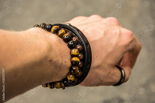 Fotografía Beaded bracelets and leather bracelet on a wrist with a tungsten ring on the thu