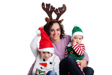 Mother and her two children wearing christmas costumes isolated on white background. Family and christmas photoshooting concept.