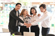 © Prathankarnpap - Business together, Four young business people confidently and motivation relax in modern office.