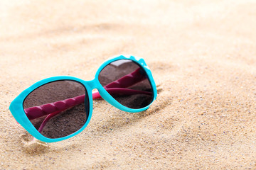 Wall Mural - Modern sunglasses on the beach sand