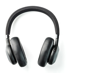 Wireless black headphones on white, isolate. On-ear headphones for playing games and listening to music tracks. Close-up