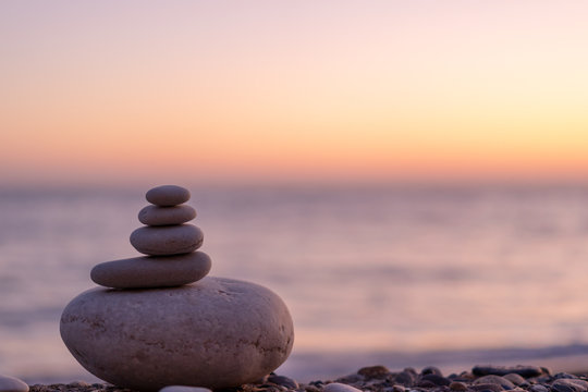 perfect balance of stack of pebbles at seaside towards sunset. concept of balance, harmony and medit