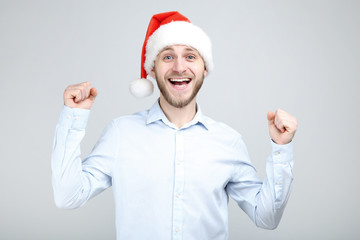 Poster - Portrait of young man with santa hat on grey background