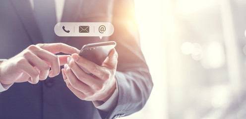 contact us, hand of businessman holding mobile smartphone with ( mail,phone,email ) icon. customer s