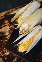Ripe Corn On Wooden Table