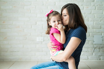 Loving Mother With Daughter At Home