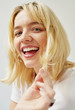 © W2 Photography/Stocksy - Dynamic portrait of a smiling young blonde woman.