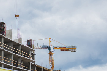 Under construction high-rise building with construction crane