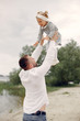© hetmanstock2 - Family playing on the sand. Father in a white shirt. Cute little girl
