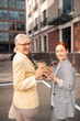© zinkevych - Two smiling businesswomen standing in front of an office building