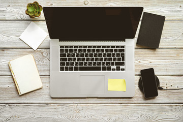 Poster - Office table workspace top view. Wooden desk with laptop, devices and plant