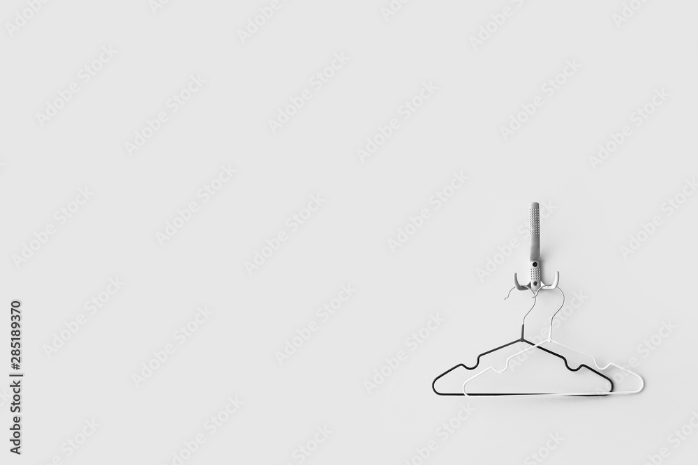 Clothes hangers on white wall