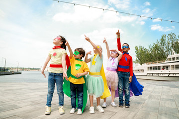 Sticker - Cute little children dressed as superheroes outdoors