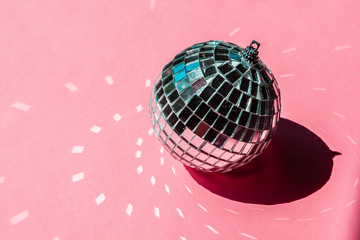 disco ball bauble on pink background.  party concept