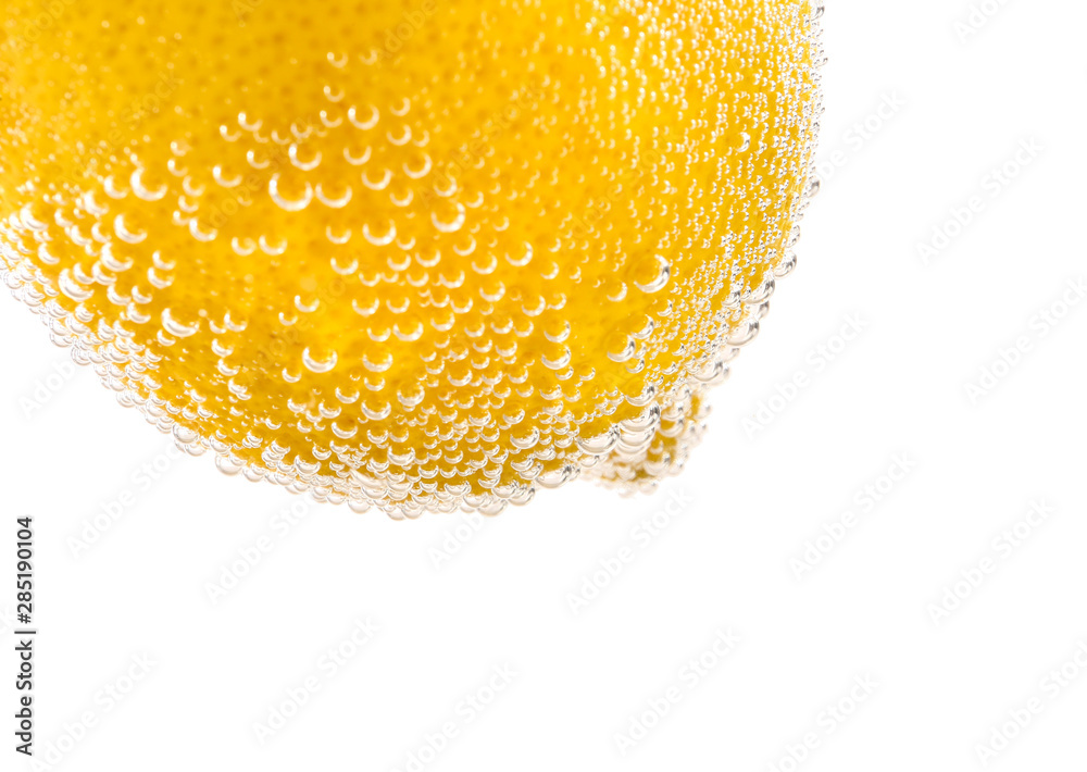 Ripe lemon in water against white background, closeup closeup