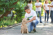 © Pixel-Shot - Teenage volunteer with cute dog outdoors