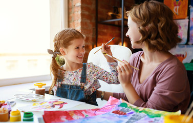 Wall Mural - mother and child daughter painting draws in creativity in kindergarten.