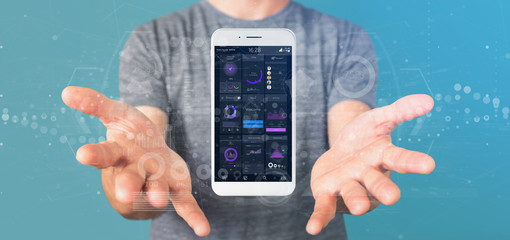 Poster - Businessman holding Smartphone with user interface data on the screen isolated on a background