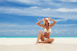 © Dmytro Sunagatov - Young fashion woman relax on the beach. Happy lifestyle. White sand, blue sky and crystal sea of tropical beach. Vacation at Paradise. Ocean beach relax, travel to islands