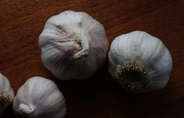 Wall Mural - Garlic bulbs on the wooden board