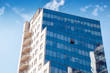 Building made out of glass with sky reflaction