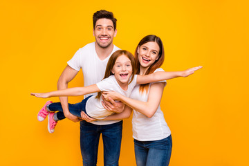 Wall Mural - Photo of three family members spending leisure time playing games wear casual outfit isolated yellow background