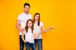 © deagreez - Daddy mommy and small foxy lady indicating arms empty space on sale wear casual outfit isolated yellow background