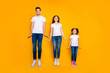 © deagreez - Full length body size view of three nice attractive slim fit sporty healthy cheerful cheery person having fun jumping up holiday isolated over bright vivid shine yellow background