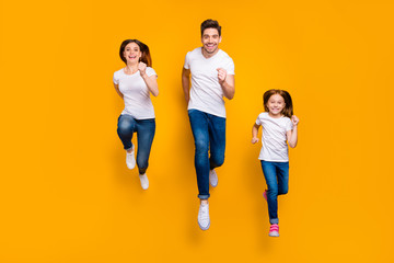 Full length body size view of three nice attractive slim fit sportive cheerful cheery person active life activity motion movement running having fun isolated over bright vivid shine yellow background