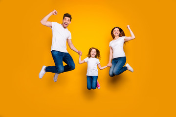 Canvas Print - Full length body size view of three nice attractive slim sporty lovely cheerful cheery person having fun rejoicing holding hands achievement success isolated over bright vivid shine yellow background