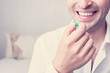 © Анастасия Семашко - A young man takes vitamins or medication, the hand with the capsule, close up, cropped image, toned