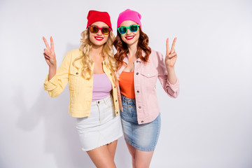 Poster - Photo of two pretty ladies showing v-sign symbols wear sun specs casual clothes isolated white background