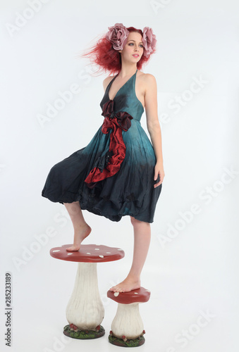 Full Length Portrait Of Red Haired Girl Wearing Fairy Costume