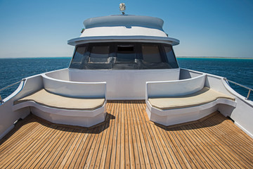 View over the bow over a large motor yacht