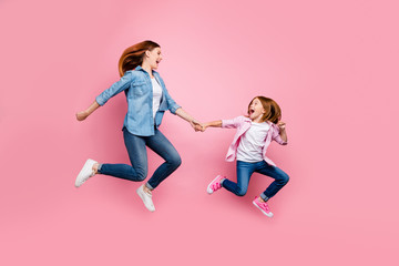 Poster - Full body photo of foxy little lady and her excited mom jumping high wear casual jeans outfit isolated pink background