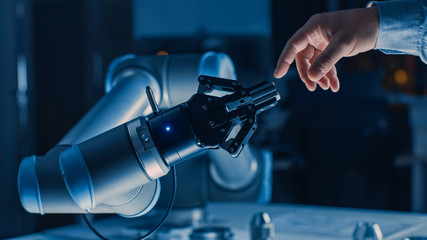 Leinwandbilder - Futuristic Robot Arm Touches Human Hand in Humanity and Artificial Intelligence Unifying Gesture. Conscious Technology Meets Humanity. Concept Inspired by Michelangelo's Creation of Adam