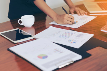 Wall Mural - Woman standing at desk and working writing document hand close up