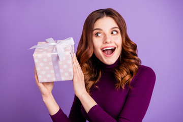 Sticker - Close up photo of funny funky lady holding hand package giftbox shake isolated over purple violet background