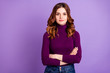 Portrait of concentrated lovely woman look listen wear denim jeans isolated over violet purple background
