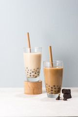 Two glasses of chocolate boba tea/ buble tea on white background.