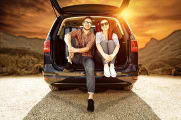 Wall Mural - Two young people and autumn trip of car 