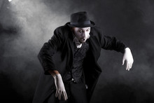 Mime Shows Theatrical Emotions On Black Background