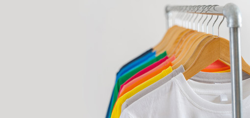 Close up of Colorful t-shirts on hangers, apparel background